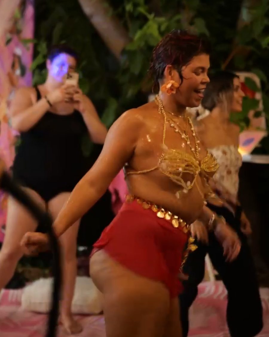 Dancer in a gold coin top mid-spin